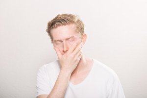 man holding his jaw in pain