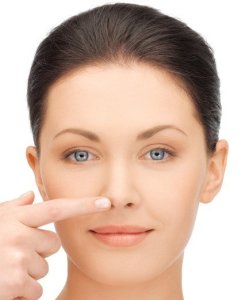 Woman  touching  her  nose